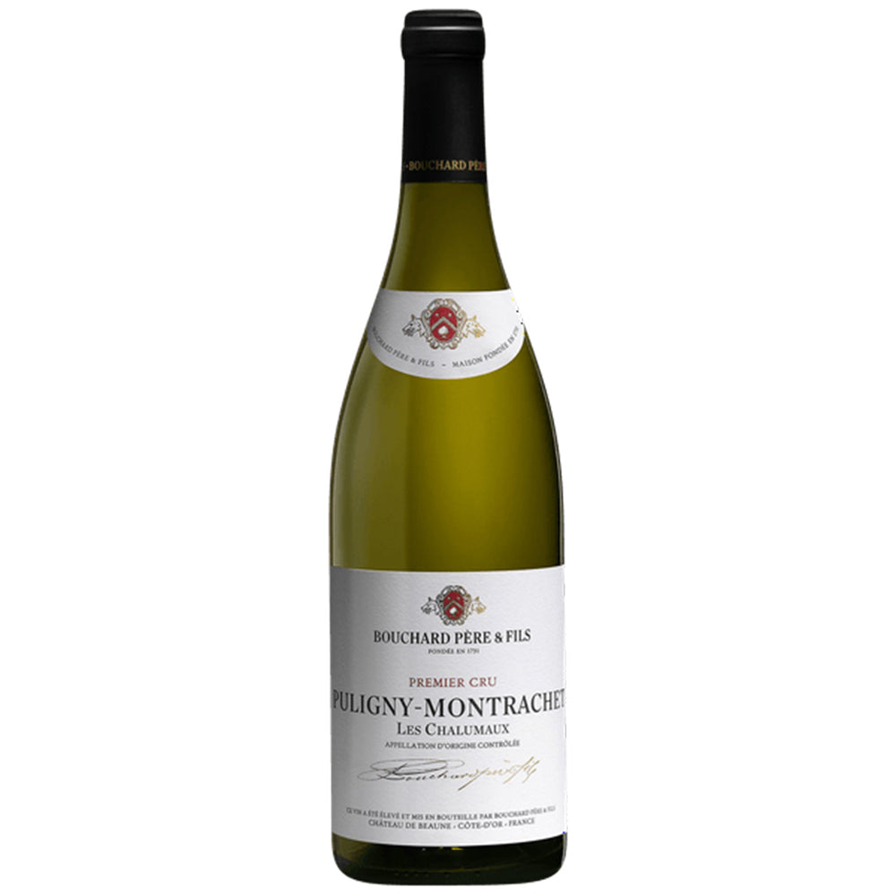 A bottle of Bouchard Pere & Fils Puligny-Montrachet Chalumeaux 1er Cru white wine, which displays a light-colored label adorned with red and gold accents, along with a dark top. The label showcases elegant text and decorative elements.