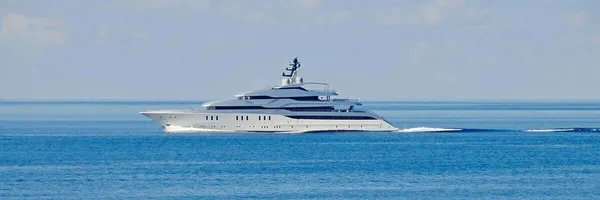 A superyacht under way on calm Mediterranean water