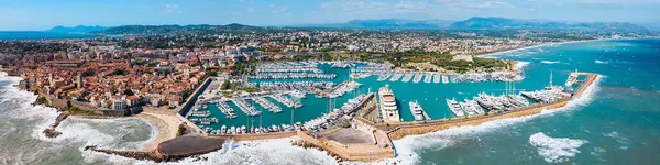 A panoramic view of Antibes with a large marina filled with yachts